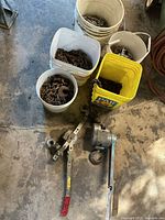 Overall view of two winches and five buckets filled with chain