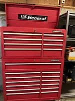 Front view of US General red metal rolling tool cabinet, top lid open