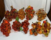 All ten Lucite grape clusters grouped on white backdrop