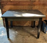 Full view of metal desk front, legs and top