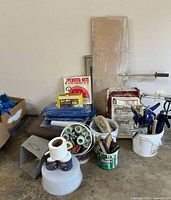 Wide view of lot with tarps, buckets, clamps, trowels