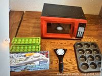 Group shot showing microwave, slicer box, thermometer, muffin pan, and ice cube trays