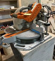 Full view of Ridgid miter saw on stand and dolly
