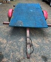 Front view of trailer showing AstroTurf deck, tongue, coupler and chain