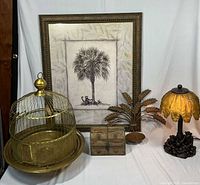 Group shot showing all five items: lamp, birdcage, framed print, wooden box, brass hook