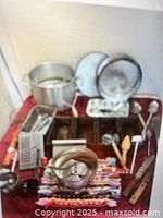 Group shot of stock pot, loaf pans, strainers, utensils
