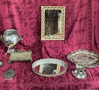 Group shot of all vintage metal items including mirrors, trays, urn, compote