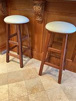 Two wooden barstools side by side showing full view