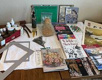 Overall view showing books, brushes, watercolor paper, sponge, mat frames and tools
