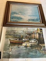 Front view showing framed beach scene print and unframed harbor print