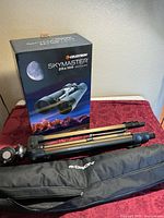 Retail box, folded tripod, and padded case displayed on table