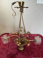 Full view of brass chandelier showing basket, arms, shades and canopy