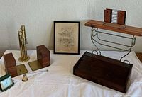 Group view of all items including bookends, coin sorter, wall shelf, framed drawing, wooden planter, clock