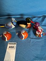 All six bird figurines grouped on blue background