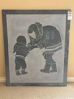 Full view of carved marble artwork leaning against wall