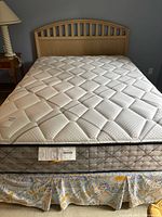 Kingsdown mattress on box spring with wood headboard visible
