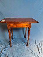 Full front view of pine table showing legs and overall form