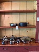 Full set of cookware displayed on shelving