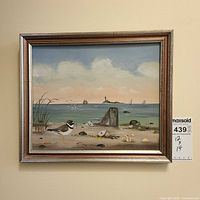 Front view of the framed seascape painting showing full artwork and frame