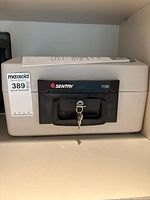 Front view of Sentry 1150 safe chest with keys inserted