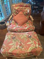 Front view of armchair with pillow and ottoman