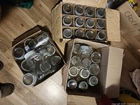 Three cartons containing rows of Crown quart jars with metal rings and glass lids
