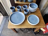 Full set on tabletop showing plates, bowls, mugs