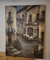 Front view of the canvas print showing entire café street scene