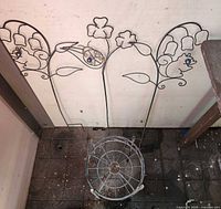 Three metal garden stakes and metal plant stand shown together