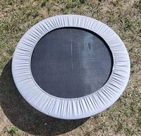 Top view of complete mini trampoline showing mat and gray cover