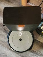 Roomba i4 positioned in Clean Base showing active power light