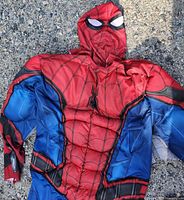 Front view of Spider-Man costume laid flat showing chest emblem and hood