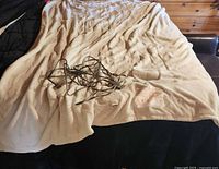 Blanket laid out showing overall size, fabric, and attached cord