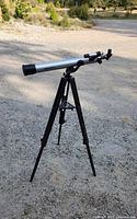 Full view of Bushnell telescope on tripod outdoors