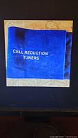 Front of blue velvet pouch with CELL REDUCTION TUNERS text