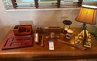 All 12 desktop accessories arranged on wooden surface including lamp, showing size and condition