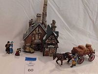 Full lot: building, wagon with horse and driver, family figurines