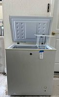 Front view of white GE/Hotpoint chest freezer with lid open