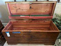 Chest open showing cedar interior, tray, lid branding