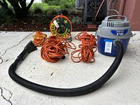 Vacuum, hose, three extension cords, cord reel