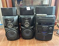 front view of entire Sony stereo system showing main unit, two large speakers, two small speakers and remote