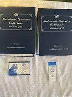Two Statehood Quarters binders Volume I & II and 2006 proof set displayed on surface