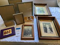 Group shot of all frames, book and vintage photos on table