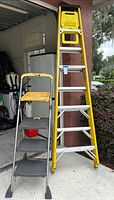 Werner 8 ft fiberglass ladder and Cosco 3-step stool standing side by side