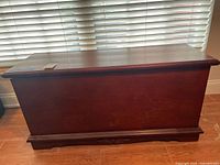 Front view of dark cherry wooden blanket chest