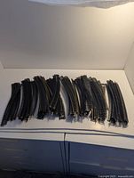 Full group of curved brass model train track pieces laid out