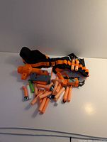 Group view of blaster, belt, attachments and darts