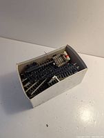 Overall view of box filled with mixed track pieces