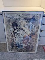 Overall view of framed print showing tennis player artwork in metal frame