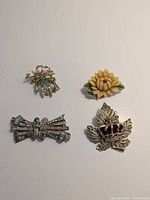 All four brooches laid out